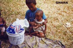 Sister with baby brother and pail of food from CFFC