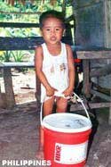 Filipino boy with pail of food