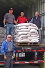 Knights of Columbus volunteers helps with loading the container